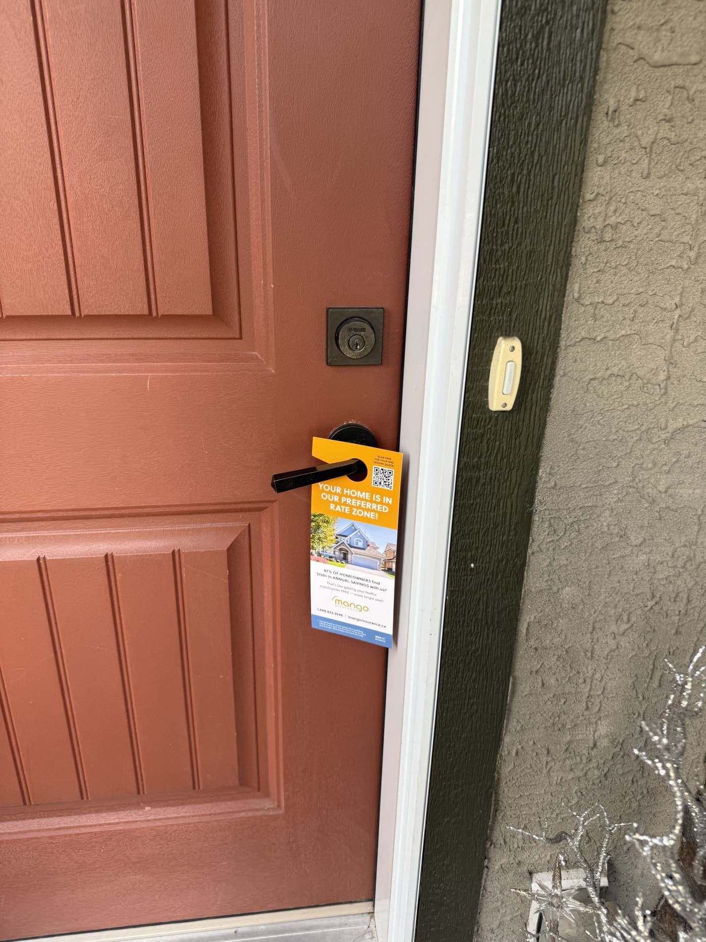 A door hanger StreetDrop delivered, hanging on a Calgary front door handle