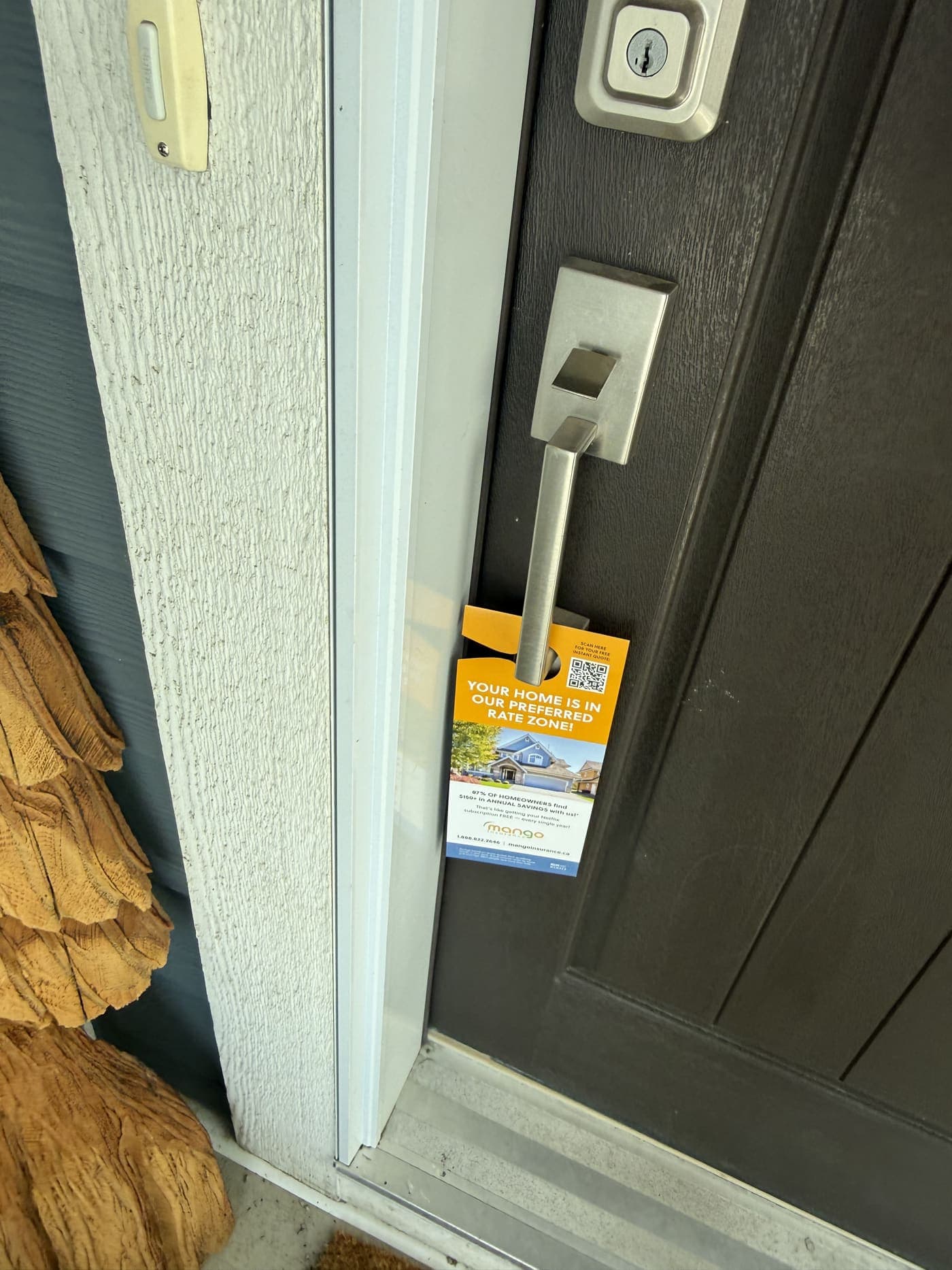 A door hanger StreetDrop delivered, hanging on a Calgary front door handle